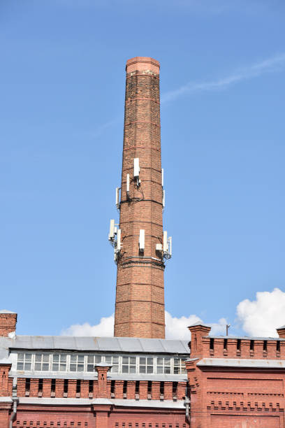 istock old factory chimney with modern antennas on it 1166851013