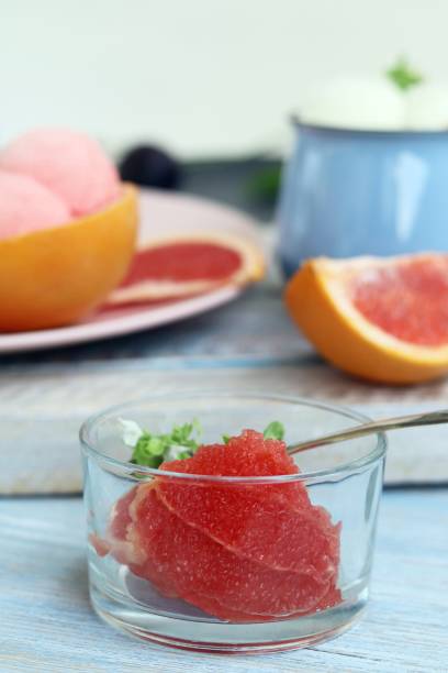 istock Natural ice cream, grapefruit, basil on a wooden table 1166859258