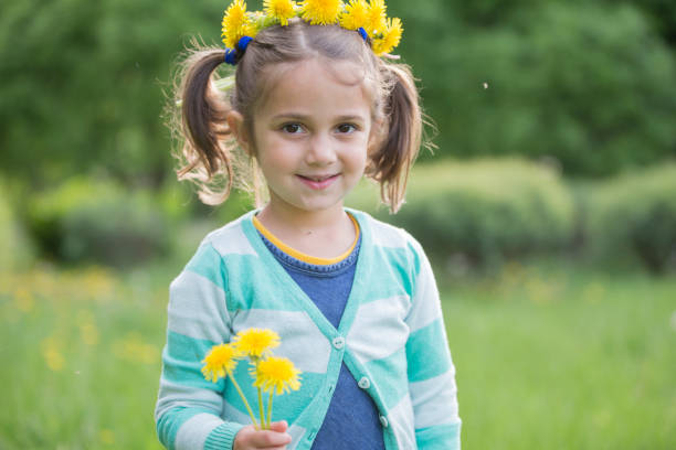 Girl with a wreath on her head with a dandelion
