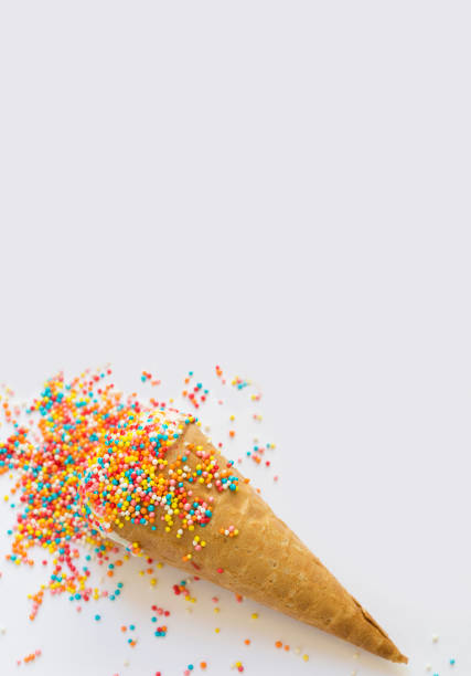 istock Ice cream in a waffle cone covered with bright sprinkles with space for text 1166868728