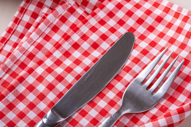 istock Cutlery table fork and knife on red tablecloth, top view, flat lay 1166870535