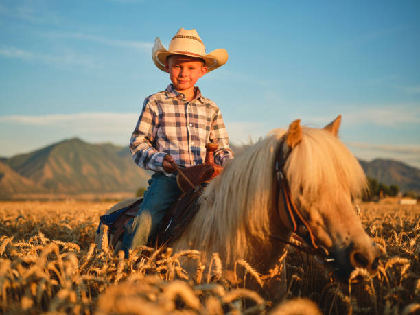 istock Young Cowboy Riding His Pony Horse 1166875000