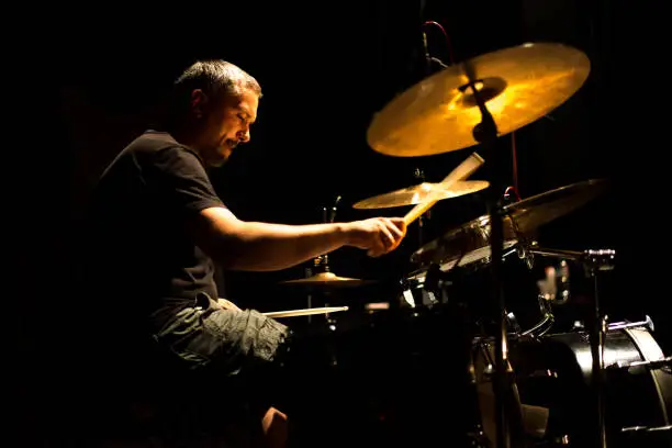 Drummer playing drums in the professional music recording studio.