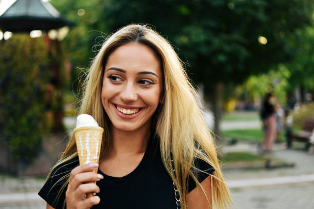 istock Woman eating ice cream on a summer day 1166878241