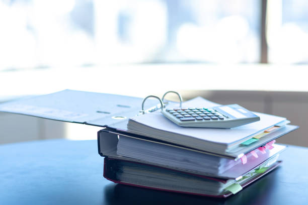 istock Workplace with notebook, pen and calculator on the desk. 1166879562