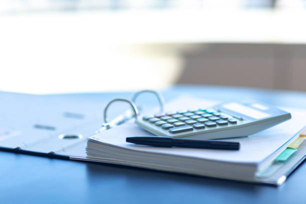 istock Workplace with notebook, pen and calculator on the desk. 1166879568