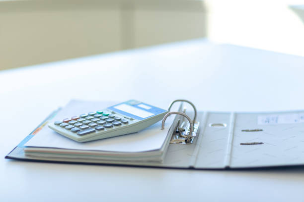 istock Workplace with notebook, pen and calculator on the desk. 1166879763