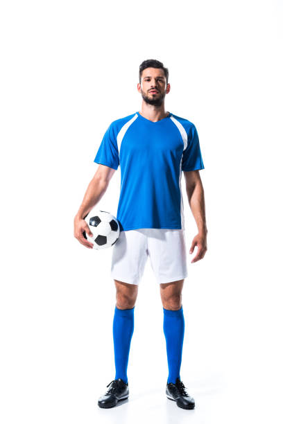 przystojny piłkarz w mundurze z piłką izolowane na białym - soccer player zdjęcia i obrazy z banku zdjęć