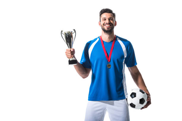 istock happy soccer player with trophy cup and medal Isolated On White 1166881354
