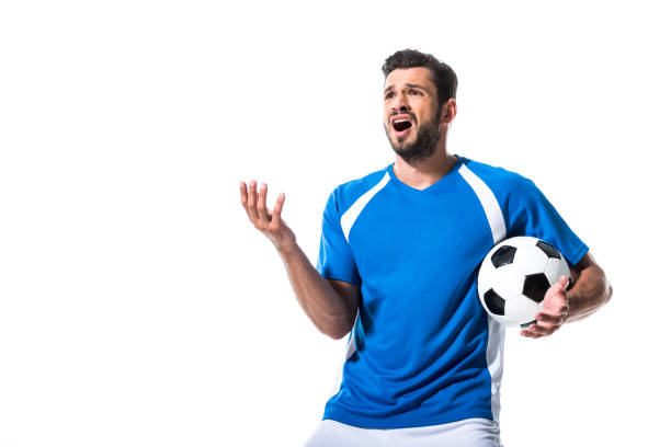 istock disappointed soccer player with ball Gesturing Isolated On White 1166881356