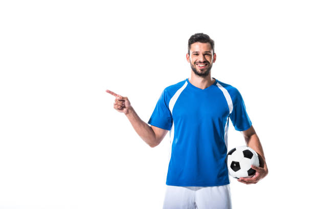 istock happy soccer player with ball pointing with finger Isolated On White 1166881362