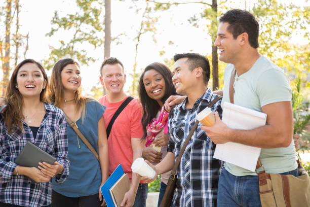 istock College student friends share laughs together on university campus. 1166881560