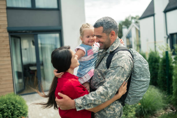 istock Dark-haired wife looking at her hero and feeling happy 1166882687