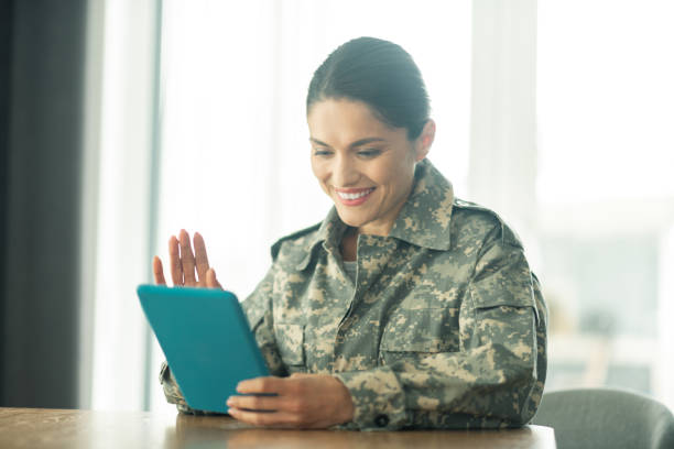 istock Woman serving in armed forces having video chat with family 1166882704