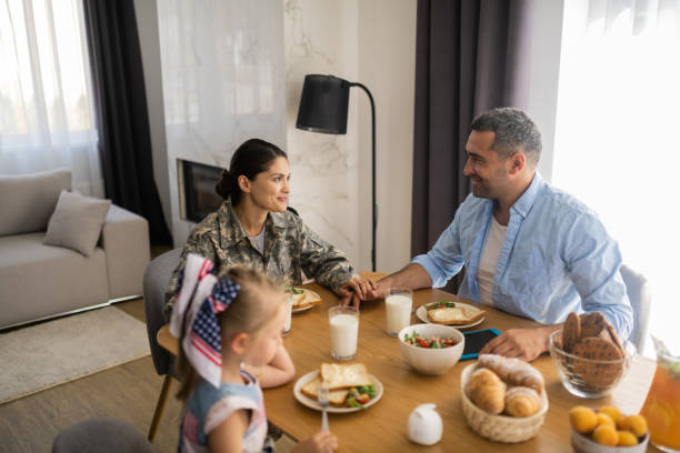 istock Military woman with husband while having family breakfast 1166883668