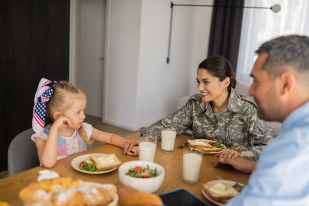 istock Dark-haired female soldier touching her cute daughter 1166883669