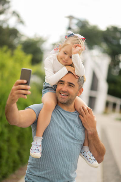 istock Handsome businessman making selfie with his daughter 1166883695