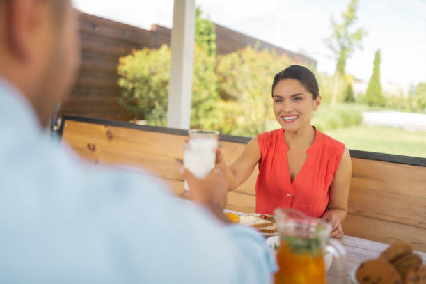 istock Beautiful wife smiling while having breakfast with husband 1166883718