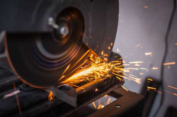 istock Cutting metal with grinder in workshop. Sparks while grinding iron. Cutting machine. 1166885834