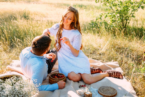 istock Young people enjoying their picnic outdoors in summer evening 1166885932