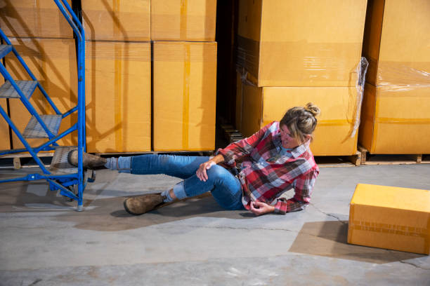 istock An industrial, warehouse, workplace safety topic. A female worker fallen off a rolling ladder. 1166890348