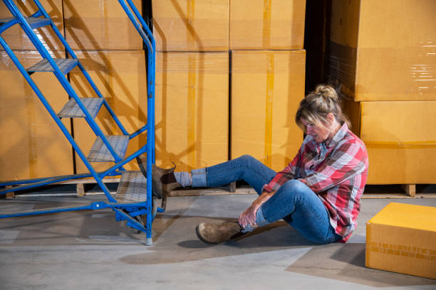 istock An industrial, warehouse, workplace safety topic. A female worker fallen off a rolling ladder. 1166890366