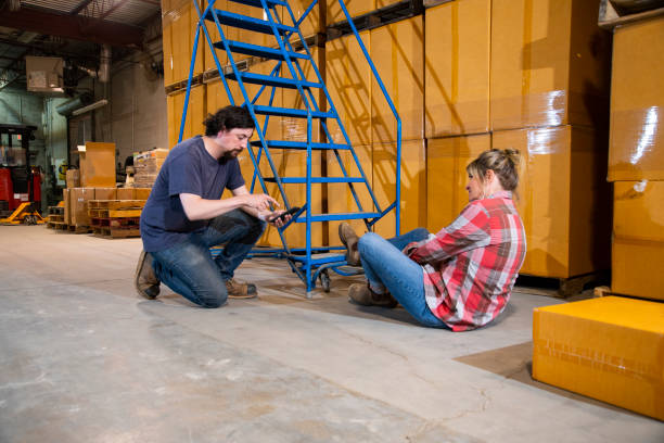 istock An industrial, warehouse, workplace safety topic. A female worker fallen off a rolling ladder. 1166891308