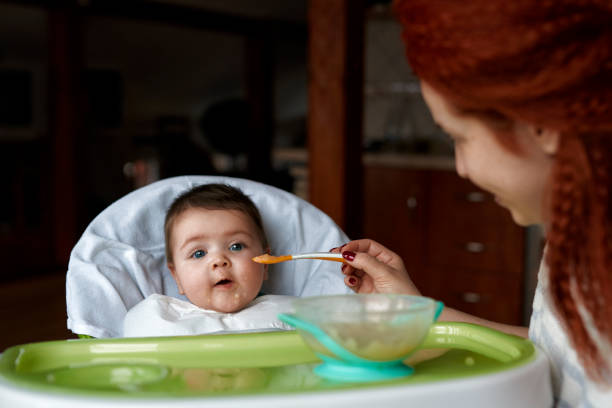 istock Mom feeding little baby 1166891449