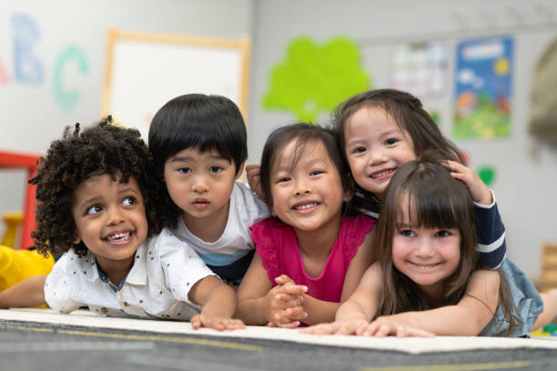 istock Group of smiling preschool students 1166891667