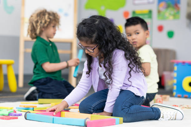 istock Multi-ethnic group of kindergarten students building with wooden blocks 1166891926
