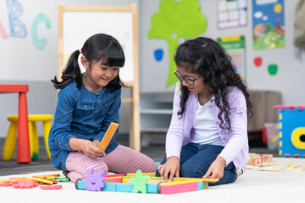 istock Multi-ethnic group of kindergarten students building with wooden blocks 1166891931
