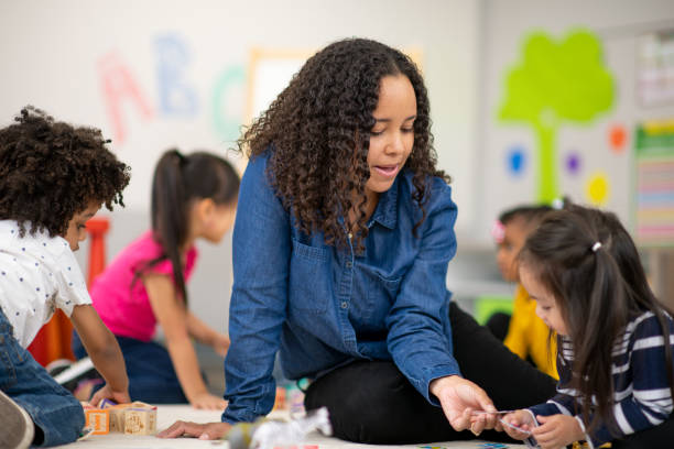 istock Kind female teacher with happy preschool student 1166892016