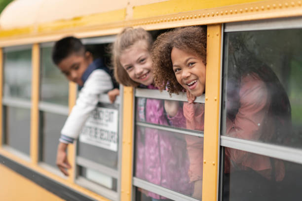 istock Diverse group of students look out school bus windows 1166892565