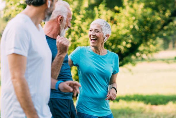 istock Smiling senior athletes jogging in the park 1166892629