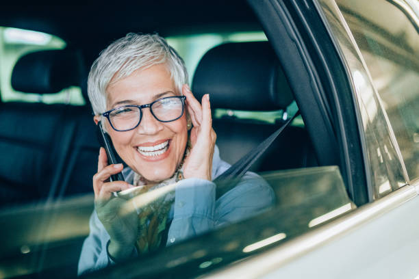 istock Businesswoman using phone in a car 1166892662