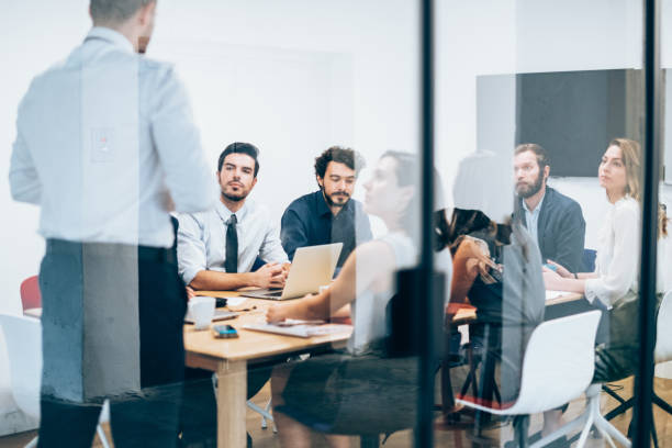 istock Businessman sharing ideas on project to team 1166892678