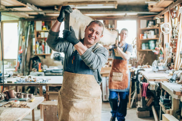 istock Carpenters carrying a wood plank 1166892687