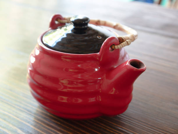 istock The red chinese teapot on a wooden table 1166892955