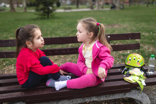 Beautiful young children enjoying a sunny day at a park.