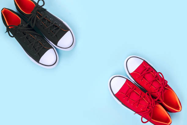 istock New black and red sneakers on pale blue background with copy space. 1166894205