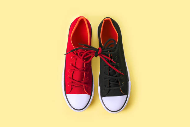 istock New black and red sneakers on yellow background with copy space. 1166894209