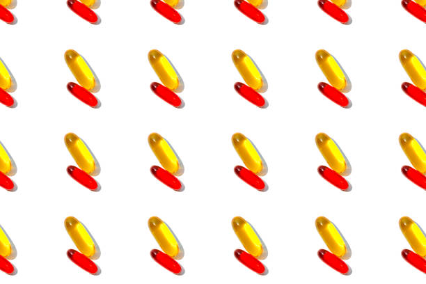 istock Red and yellow pills pattern isolated on white background. 1166896257