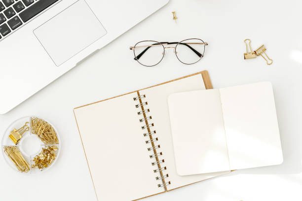 istock Flat lay, top view office table desk. Workspace with laptop, office supplies, glasses, notebookes on white background. 1166898909