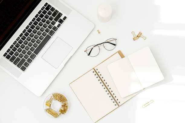 istock Flat lay, top view office table desk. Workspace with laptop, office supplies, glasses, notebookes on white background. 1166898949