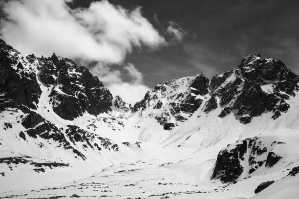 istock Black and white snowy mountains with traces from avalanches 1166900760
