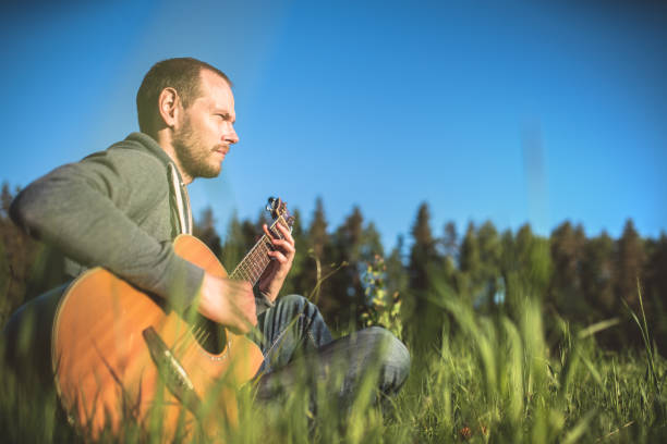 istock Man playing acoustic guitar outdoors 1166900920