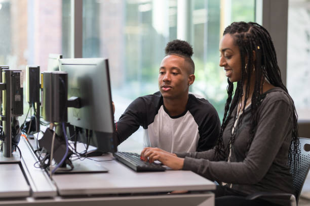 istock College students working at a computer station in the library 1166900962