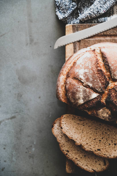 istock Freshly baked sourdough bread loaf and slices, vertical composition 1166900998