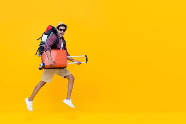 istock Handsome Indian tourist man with backpack holding baggage and jumping 1166903768