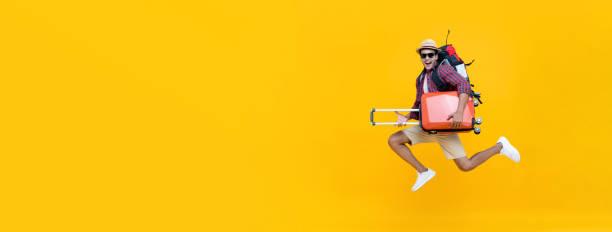 istock Handsome Indian tourist man with backpack holding baggage and jumping 1166903882